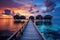 Sunset on Maldives island, luxury water villas resort and wooden pier.AI Generated