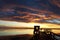 Sunset. The man on the pier. Beautiful clouds. Background