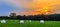 Sunset in Meadow with Hay Bales