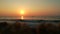 Sunset at Mediterranean sea. Golden sunlight reflecting on a beach. Sun shining in the evening - waves breaking on the shore. gold