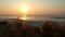 Sunset at Mediterranean sea. Golden sunlight reflecting on a beach. Sun shining in the evening - waves breaking on the shore. gold