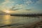 Sunset on the Mediterranean sea. Silhouettes of fishermen on the breakwaters. Beautiful sunset on the beach . Fishermen by the sea