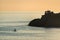 Sunset on Mediterranean sea, yacht, chapel on the rocks, Madonnina della Punta, Bonassola, Liguria, Italy