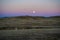 Sunset with moon and moonrise on the high desert plains