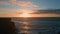 Sunset mountain hill silhouette sea coastline. Drone view dark cliffs calm ocean