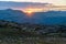 Sunset in the mountains with cotton flowers infront during summer holiday. warm sunburst over peer gynt cabin, formokampen and roa