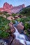 Sunset in mountains near river. Sunlight reflected on mountain tops. Golden light from sky reflected in a mountain river. Ergaki.