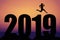 Sunset with new year 2019 silhouette with jumping man as symbol