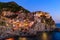 Sunset and night view of Manarola, one of the five Mediterranean villages in Cinque Terre, Italy