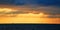 Sunset. Ocean scenery. Virgin nature landscape. Beautiful golden sky. Calming water. Open sea. Floating boat on horizon