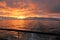 Sunset off a cruise ship with railing in foreground