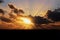 Sunset in the open ocean. Colorful views of the surface of the water and the sky with clouds over ocean.