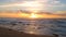 Sunset over Atlantic ocean in Portugal with dramatic clouds and orange reflections on water surface