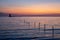 Sunset over bay with Delaware Breakwater Lighthouse in distance