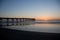 Sunset over beach and pier