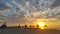 Sunset over the beach with reed umbrellas