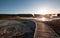 Sunset over boardwalk at the Old Faithful geyser basin in Yellowstone National Park in Wyoming USA
