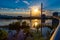 Sunset over Bob Kerrey Pedestrian bridge and swollen Missouri River at Omaha Riverfront