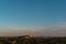 The sunset over the buildings and the forest from Villeneuve, Avignon