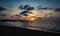 Sunset over calm ocean with balinese boat