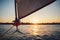 Sunset over the city from the sailboat. Sailboat winch, sail and nautical rope yacht detail. Yachting, marine background