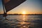 Sunset over the city from the sailboat. Sailboat winch, sail and nautical rope yacht detail. Yachting, marine background