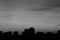 Sunset over the city. silhouettes of houses, black and white photo, selective focus