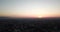 Sunset over the city. Visible horizon, red rays sun, the shadows from buildings and smog.