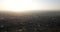 Sunset over the city. Visible horizon, red rays sun, the shadows from buildings and smog.