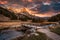 Sunset over Claree valley with Main De Crepin peak in autumn forest at French Alps, France