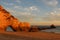 Sunset over cliffs at deserted beach in Algarve, Portugal