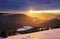 Sunset over color mountain silhouette with rays