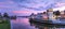 Sunset over the colorful shops of the Village on Venetian Bay