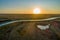 Sunset over countryside agricultural land and winding river.