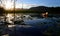 Sunset over dam with canoe in background, Garden Route, South Africa