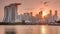 Sunset over the downtown skyline of Singapore as viewed from across the water from The Garden East timelapse. Singapore.