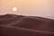 Sunset over the dunes in the desert of Morocco