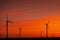 Sunset over an eolian wind farm with amazing sky color. Alternative eco energy