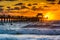 Sunset over the fishing pier and Gulf of Mexico in Naples, Florida.