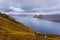 Sunset over the fjord and steep coast in Funnings, Faroe Islands, Denmark