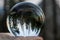 Sunset over Forest and Mountains with Moon Captured in Glass Ball