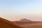 Sunset over Fossil Rock mountain ridge and golden desert, Sharjah, United Arab Emirates