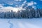 Sunset over fresh snowshoe tracks on Lake Lillian, BC