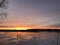 Sunset over frozen river backwaters