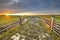 Sunset over gate in lowland meadow