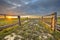 Sunset over gate in lowland meadow