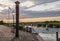 Sunset over the harbor of Ribe with the high water mark column in the front, Denmark