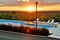 Sunset over the hill and hotel with the pool and loungers
