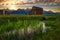 Sunset over a historic barn at Mormon Row in Grand Teton National Park, Wyoming