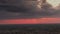 Sunset over housing development. Aerial wide descending shot of houses and homes in city suburb.